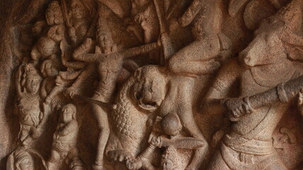 Mahishasuramartini Cave Temple. Statues carved in the rock show Mahishan and Durga fighting. The...