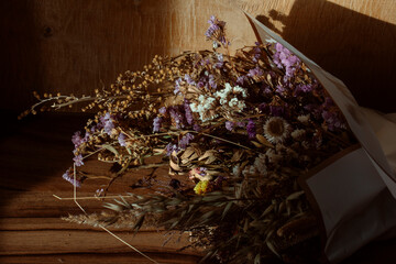 Beautiful bouquet of various dried flowers in the sun close up