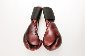 Top down side view of a pair of vintage leather boxing gloves