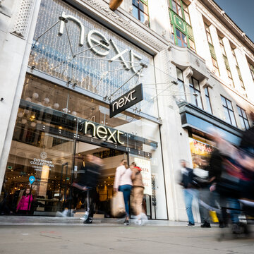 Next Store, Oxford Street, London. Shoppers Passing The Entrance To The Popular High Street Retail Fashion Store In London's Busy Shopping District.