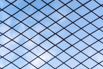 Clear sky seen through the barbed wire fence