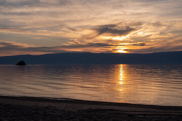 sunset over the lake. Russia, lake Baikal, island Olkhon. Sunset. Background lake. 