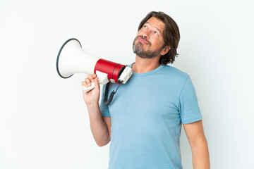 Senior dutch man isolated on white background holding a megaphone and thinking