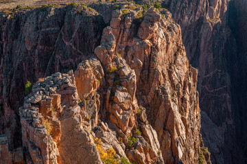 USA, Colorado. Black Canyon of the Gunnison National Park, early morning light on steep, metamorphic cliff face at Rock Point.