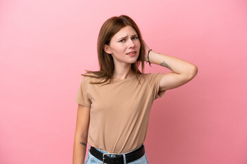 Young English woman isolated on pink background having doubts