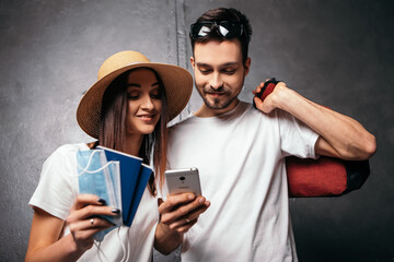 Couple standing hug embrace hold passports and blue face disposable medical masks. Spouse husband...