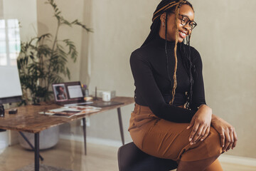 Creative young woman smiling while sitting alone