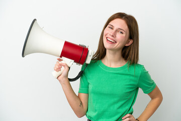 Young English woman isolated on white background holding a megaphone and smiling