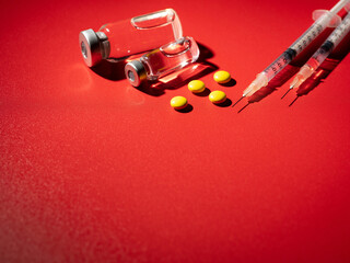 Yellow pills, syringe and drug bottle 