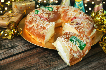 Roscon de reyes with cream and christmas ornaments. Kings day concept spanish three kings cake.Typical spanish dessert for Christmas. Selective focus