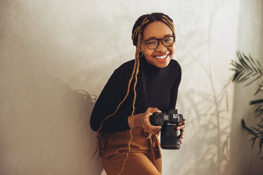 Artistic young photographer smiling in her office