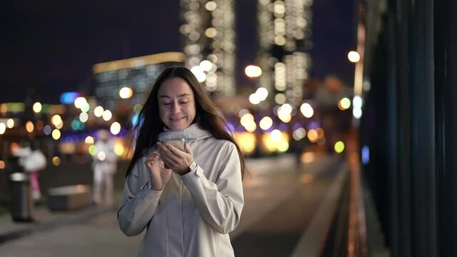 smartphone user on city street in night time, portrait of internet addicted person