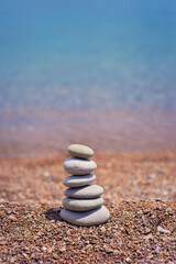 Fototapeta na wymiar Stack of pebble stones with sea on the background