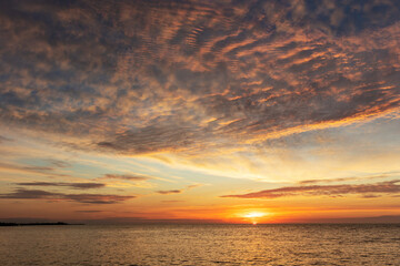Naklejka na ściany i meble Vivid sunrise clouds over the Atlantic Ocean from Higgs Beach in Key West, Florida, USA