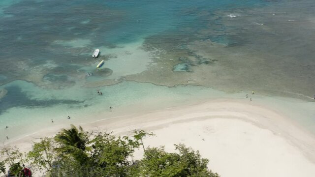 People Enjoying Water Sports And Summer Swimming In Playa Teco Maimon Beach In Puerto Plata Dominican Republic - aerial shot