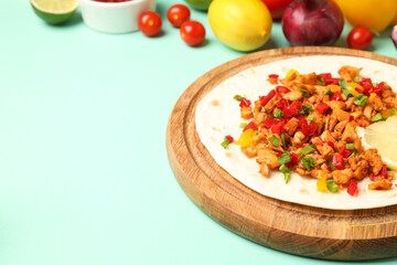 Concept of tasty food with taco on mint background