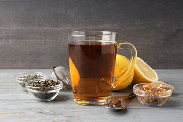 Concept of hot drink with tea on gray wooden table