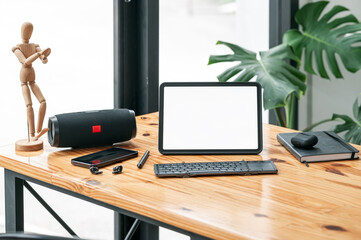 Mockup creative workspace with blank screen portable tablet.