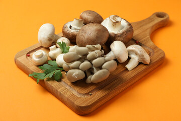 Concept of tasty food with mushrooms on orange background