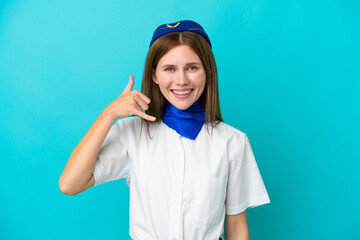 Airplane stewardess English woman isolated on blue background making phone gesture. Call me back sign
