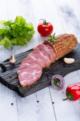 Fresh sausages and ham slices on wooden cutting board, delicious snack, spicy and high quality meat...