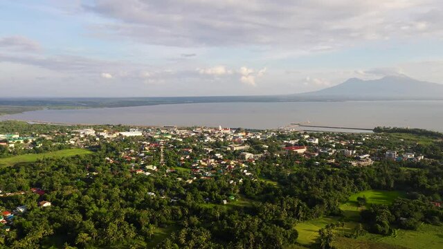 Asian town by the sea, top view. Tropical landscape with a town by the sea. Sorsogon City, Luzon, Philippines. Summer and travel vacation concept.