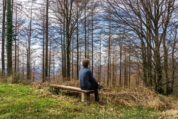 Naklejka na ściany i meble Lonely man sitting in nature