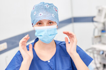 Fototapeta na wymiar Young woman as a surgeon or operating room nurse with a face mask