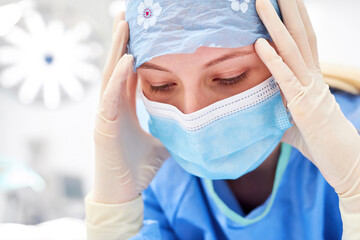 Surgical nurse or nurse with hands on head