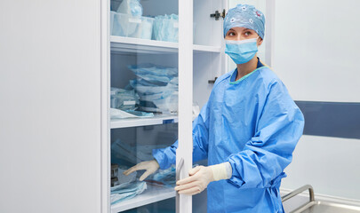 Nurse fetches nursing supplies from a closet