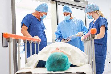 Group of doctors and nurse with patient before surgery