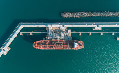Aerial top down view of an oil tanker ship in process of loading