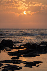 USA, Hawaii, Big Island of Hawaii. Kohanaiki Beach Park, Sunset over waves and volcanic rock.