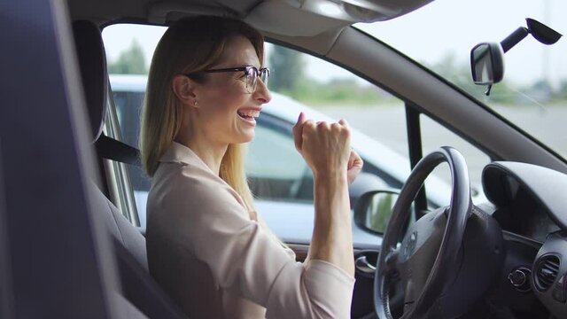 Active Middle-aged Woman Dancing In Car Having Fun In Traffic Jam, Enjoying Ride