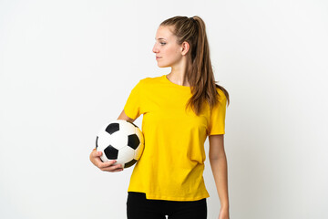 Young caucasian woman isolated on white background with soccer ball