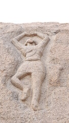 Ancient sculpture of a human form carved in rock. The rock is located in the background