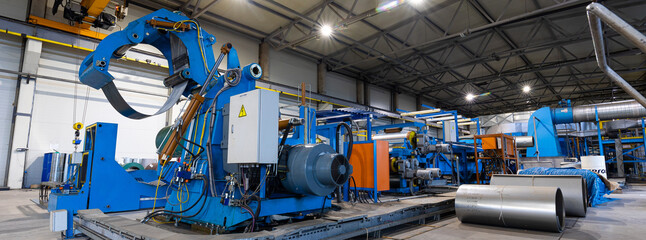 Panoramic photo. Metal sheet profile forming machine, process of making steel tile for roof, industrial manufacturing. Background of plant and factory