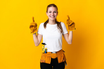 Young electrician woman isolated on yellow background pointing up a great idea