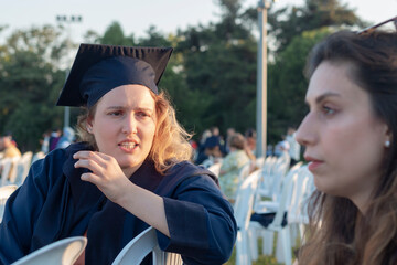 Sisters arguing at graduation celebration. One of them is graduated. 