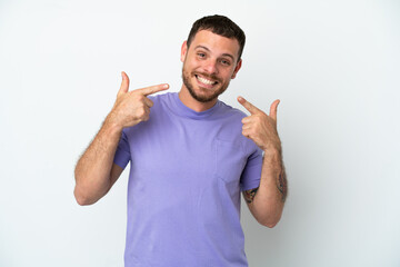 Naklejka premium Young Brazilian man isolated on white background giving a thumbs up gesture