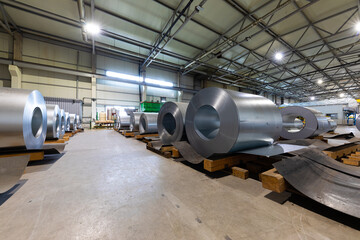 Photo of roll of painted galvanized steel sheet at cutting machine. Industrial machine for metal sheet roof coils cut