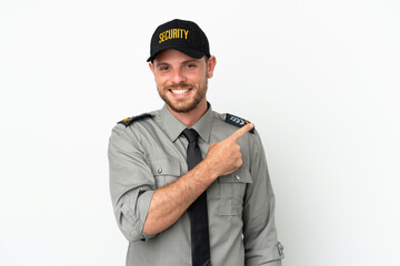 Young security Brazilian man isolated on white background pointing to the side to present a product