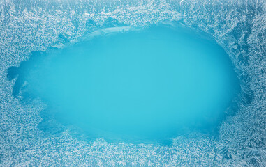 Frost patterns on frozen winter window as a symbol of Christmas wonder. Christmas or New year background.