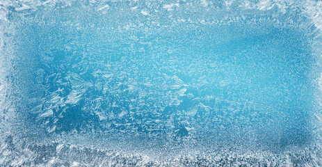 Frost patterns on frozen winter window as a symbol of Christmas wonder. Christmas or New year...