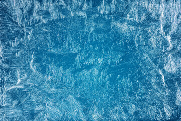 Frost patterns on frozen winter window as a symbol of Christmas wonder. Christmas or New year background.