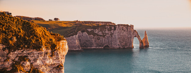 coastal landscape along the Falaise d'Aval the famous white cliffs of Etretat village, with the...