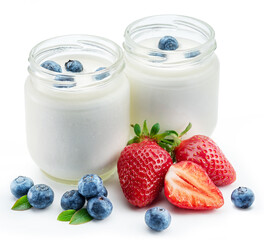 Two glass containers with plain yoghurt and berries isolated on white background.