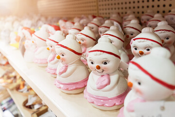 Christmas ceramic toys snowmen stand on a store shelf,
Christmas shopping.
Gifts and toys for decorating the Christmas tree on
Christmas and New Year,
