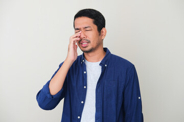 Adult Asian man got nasal congestion gesture - obrazy, fototapety, plakaty