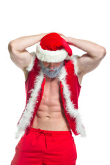 Christmas. Portrait of muscular sexy strong athlete in Santa Claus costume with gray beard posing showing his abs isolated on white background
